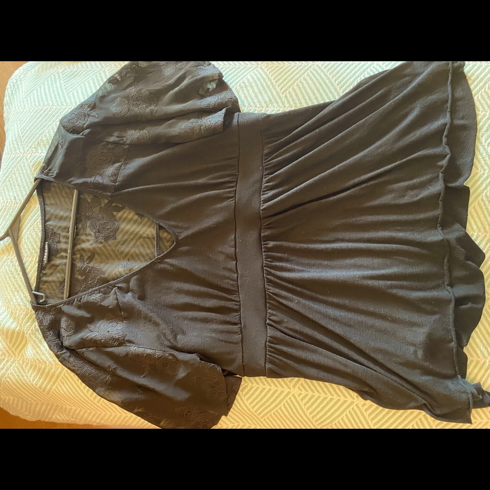 Knit top with sheer floral sleeves and back.